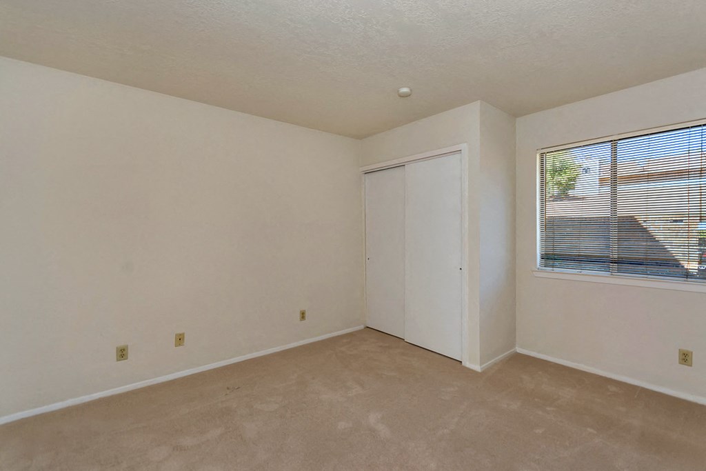 an empty room with a window and a door