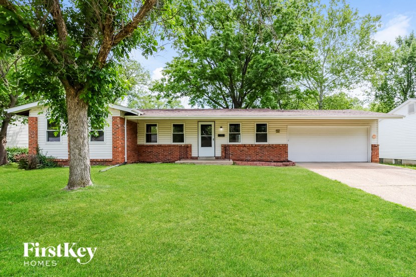 A house with a white garage door is for sale.