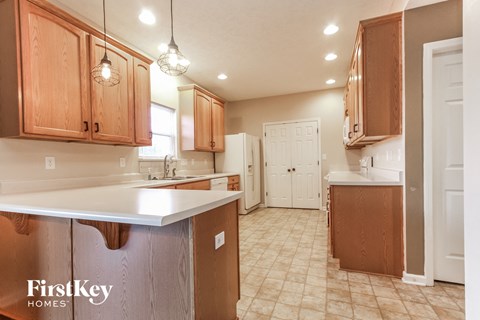 A kitchen with wooden cabinets and a white countertop.