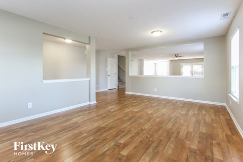 the living room and dining room with hardwood flooring