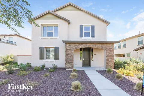 A house with a gravel driveway in front of it.
