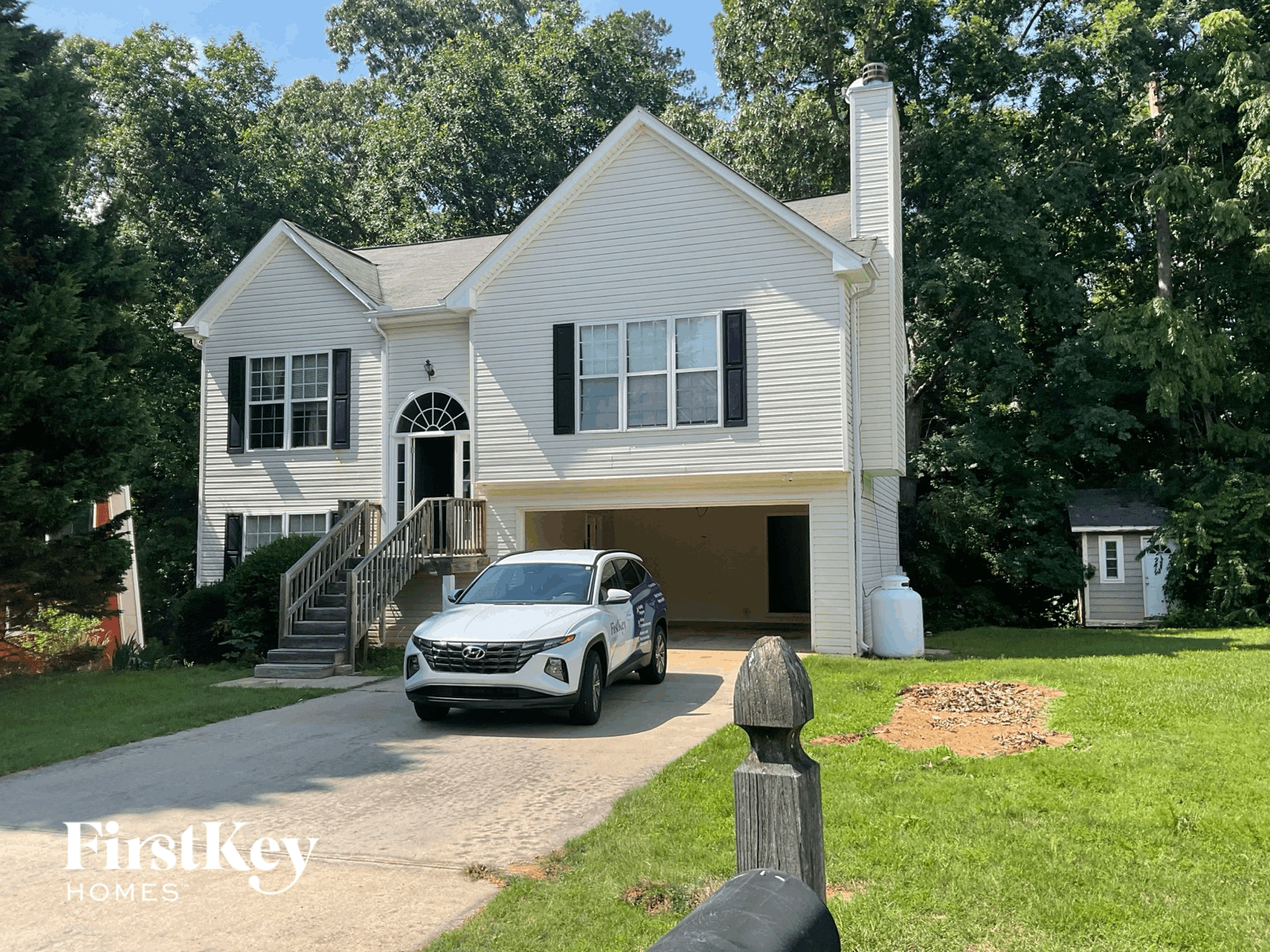 a car parked in a driveway in front of a house