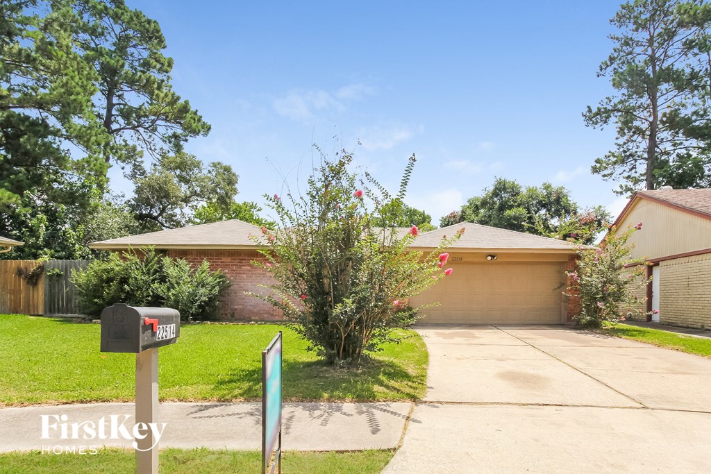 a house with a driveway and a parking meter in front of it