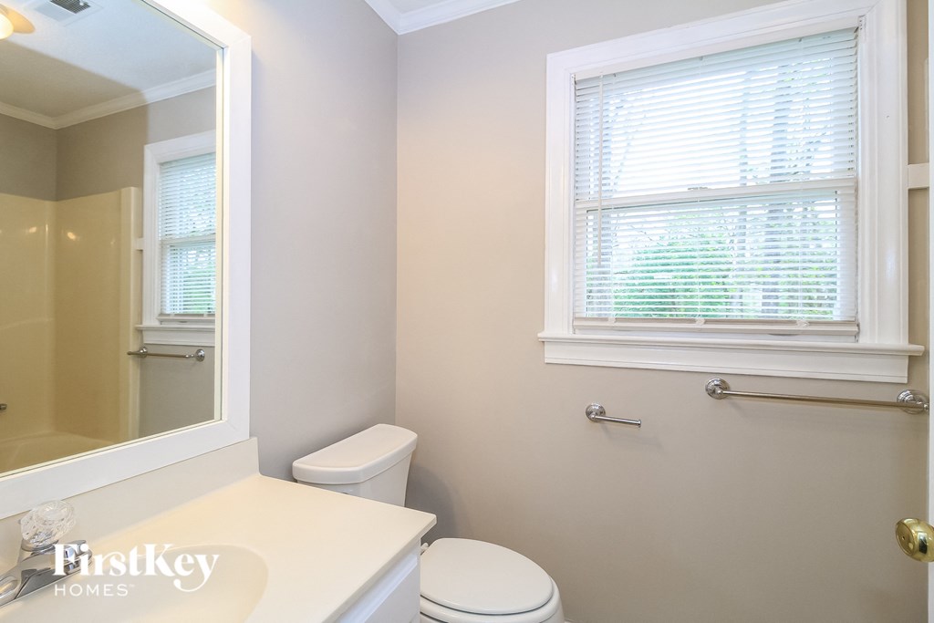 a small bathroom with a toilet and a mirror