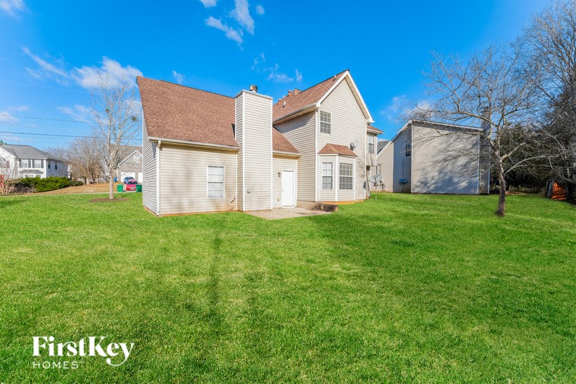 a white house with a yard in front of it