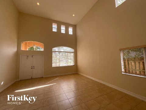A spacious room with a tiled floor and a large window.