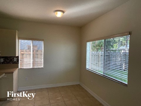 A room with a window and a tiled floor.