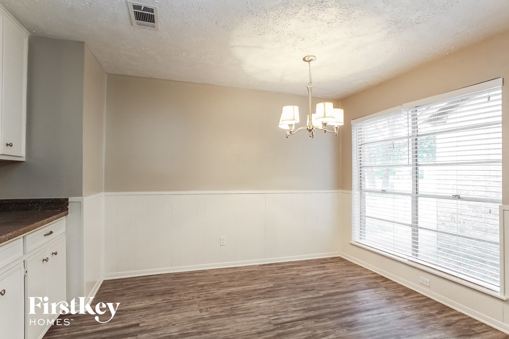 a kitchen and dining room with a large window