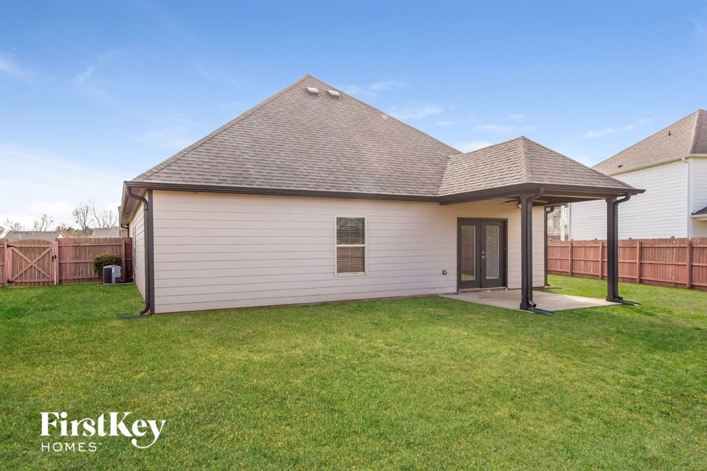 A house with a white exterior and a brown roof is for sale.