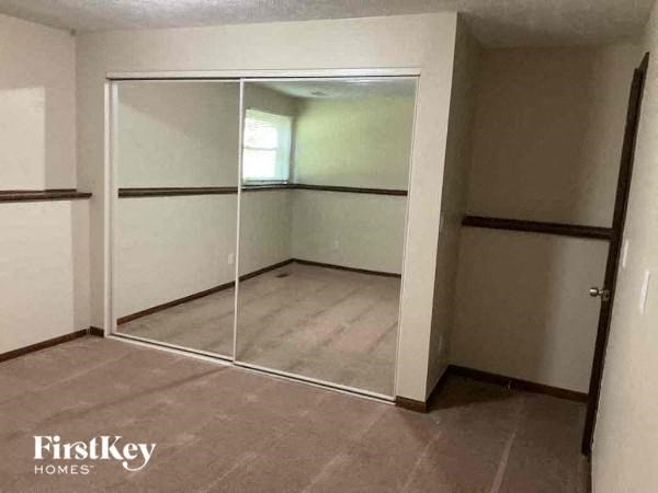 A room with a glass door and a wooden floor.