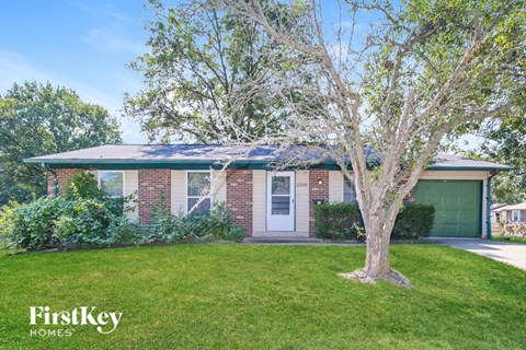 A house with a tree in front of it.