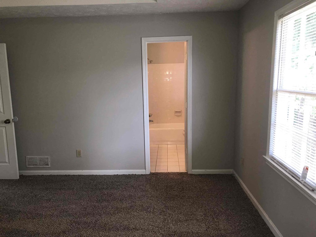 A room with a doorway leading to another room.