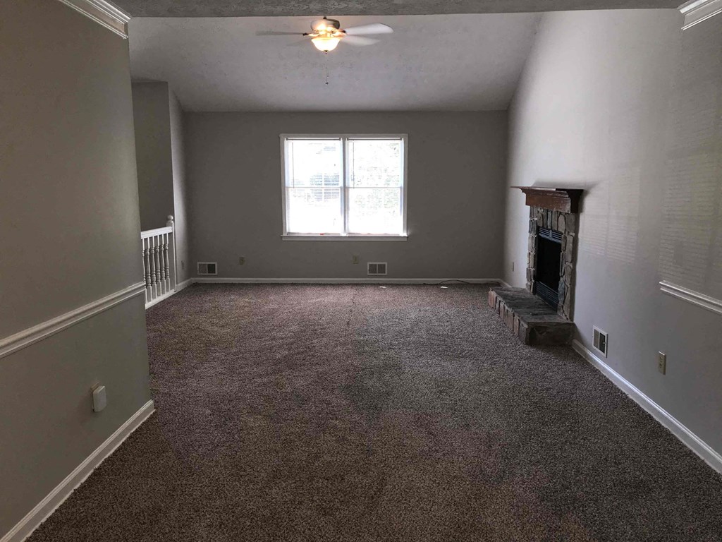 A room with a fireplace and a window.