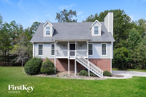 A house with a grey roof and a white porch.