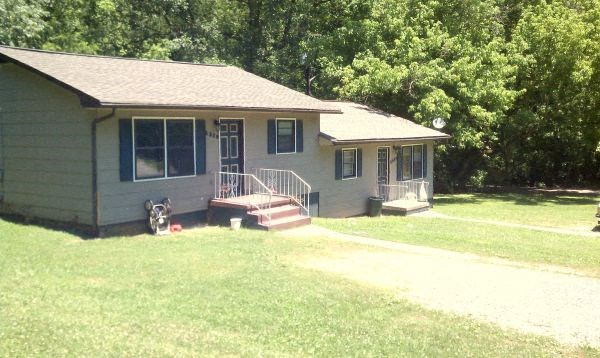 a house with a porch and a bike parked in the yard