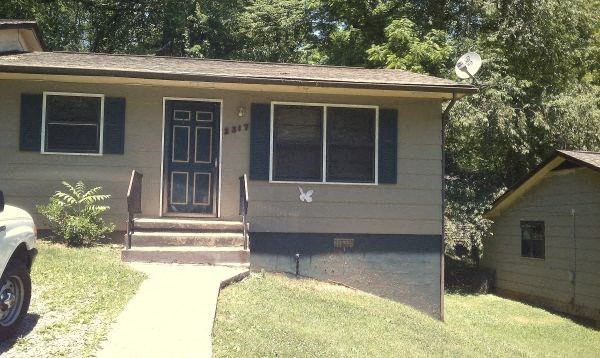 the front of a house with a porch and steps