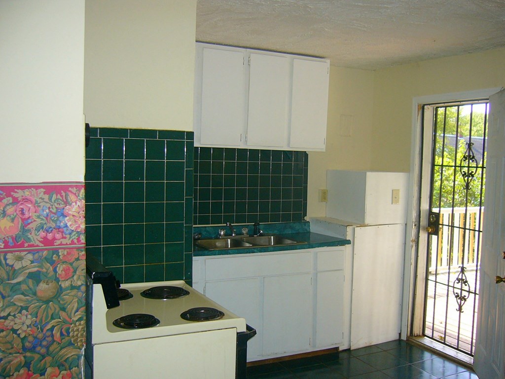 a kitchen with a stove and a sink