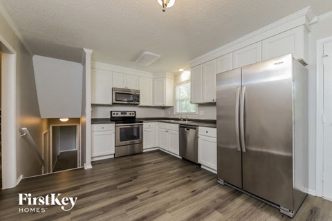 a kitchen with stainless steel appliances and white cabinets