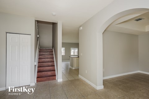 A room with a staircase and a window.