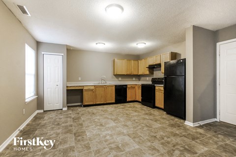 a kitchen with black appliances and wooden cabinets