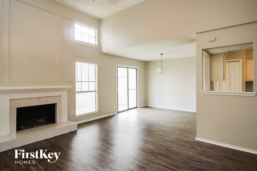 the living room of an empty house with a fireplace