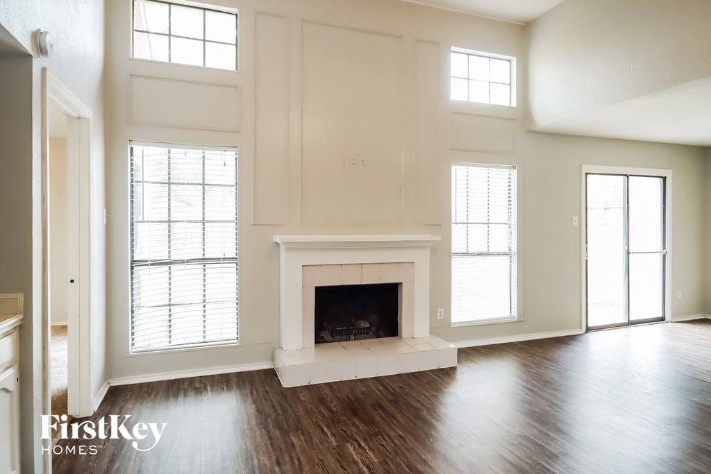 the living room of a new home with a fireplace