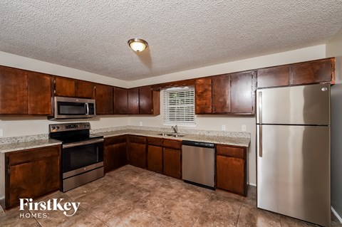 a kitchen with stainless steel appliances and wooden cabinets