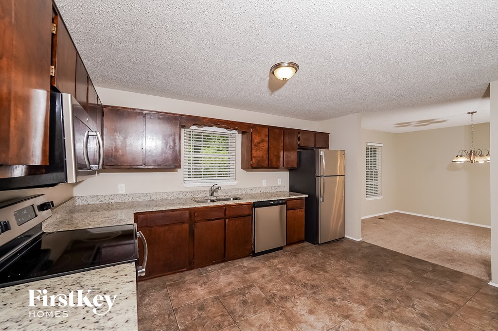 a kitchen with stainless steel appliances and wooden cabinets