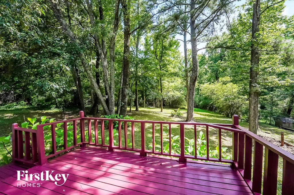 a red deck with trees in the background