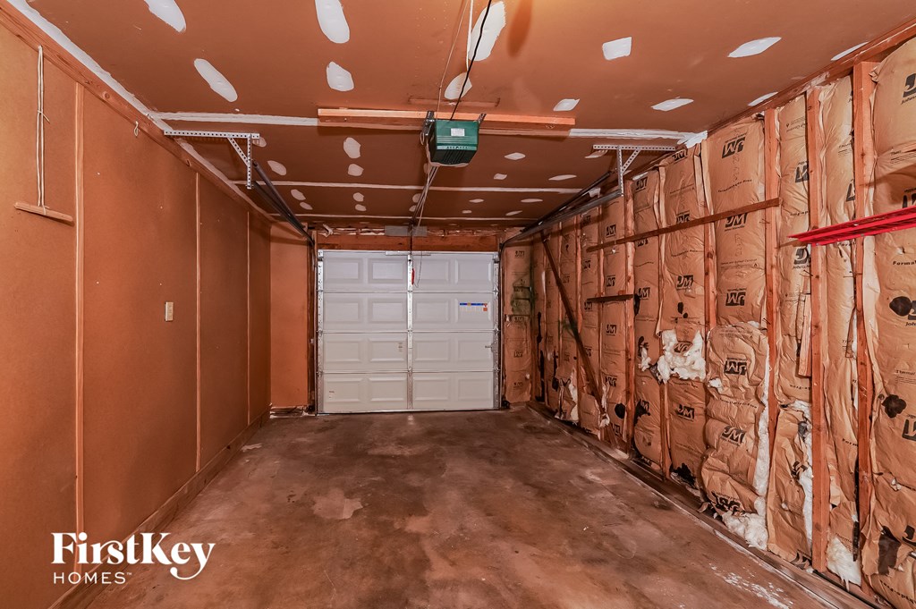a garage with wood paneling and a white door
