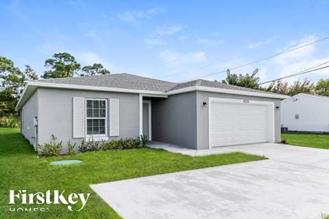 A two-car garage with a house attached is for sale.