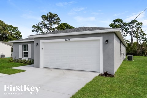 A two-car garage with the number 2325 on the front door.