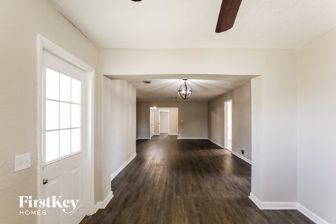 the living room and dining room of an empty house