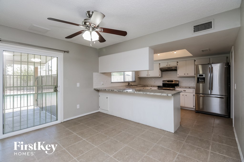 A kitchen with a refrigerator, stove, and oven.