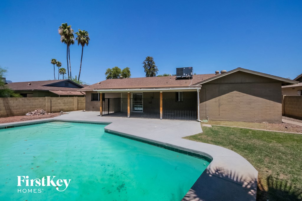 A house with a pool in the backyard.