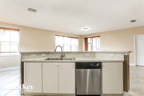 A kitchen with a sink and a dishwasher.