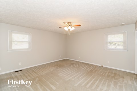 a bedroom with a ceiling fan and a hardwood floor