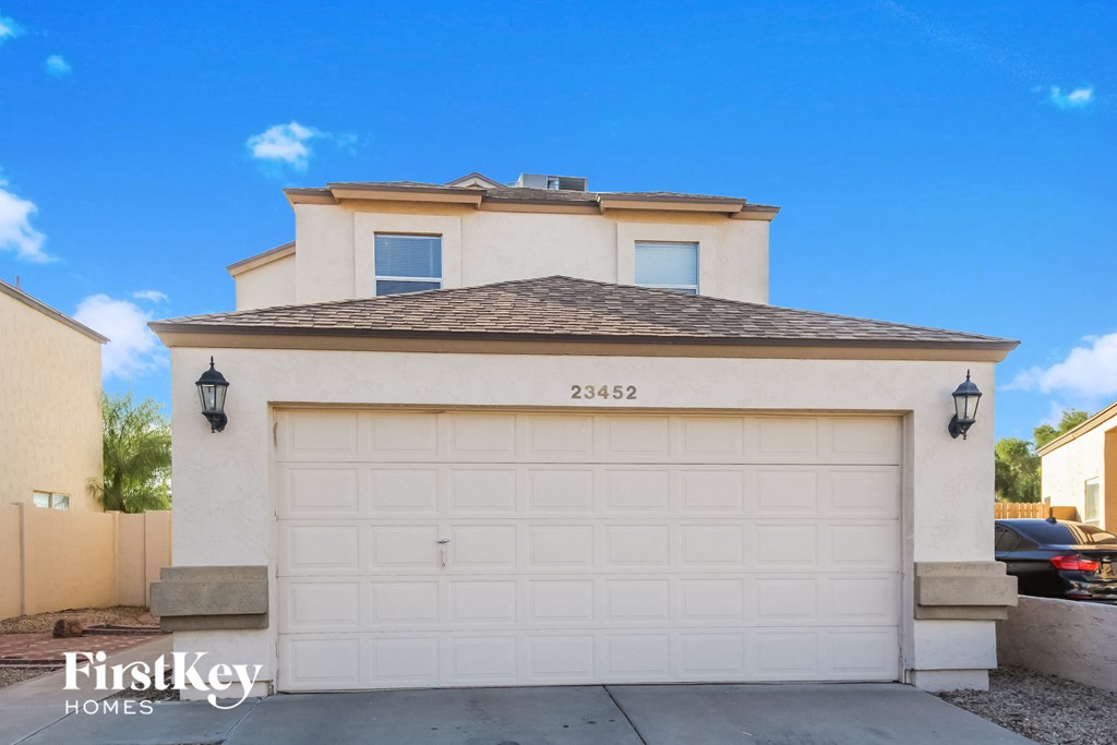 a white garage door in front of a house