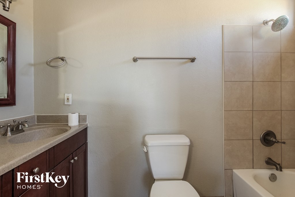a bathroom with a toilet and a sink and a shower