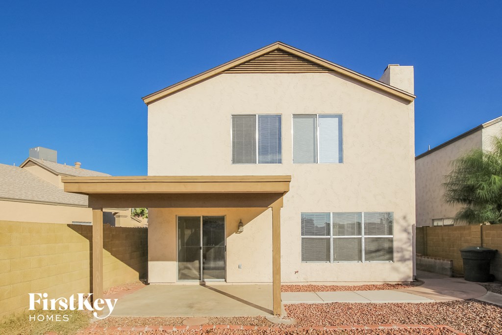 a white house with a covered porch and a clear blue sky