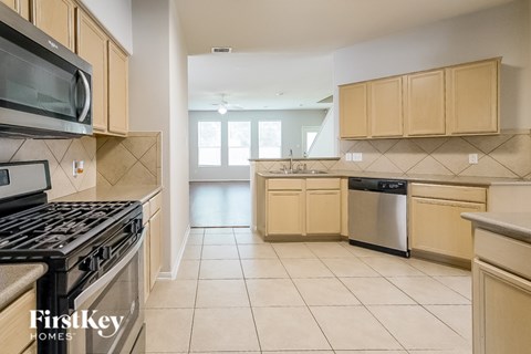 A kitchen with a stove top oven and a microwave.