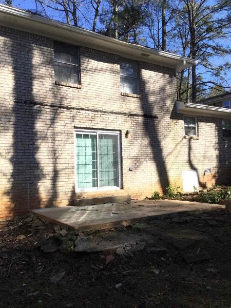 a white brick house with a green door