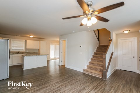 A spacious room with a staircase leading to the upper floor.
