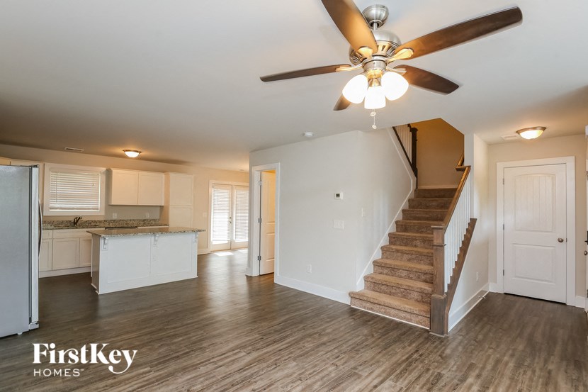 A spacious room with a staircase leading to the upper floor.