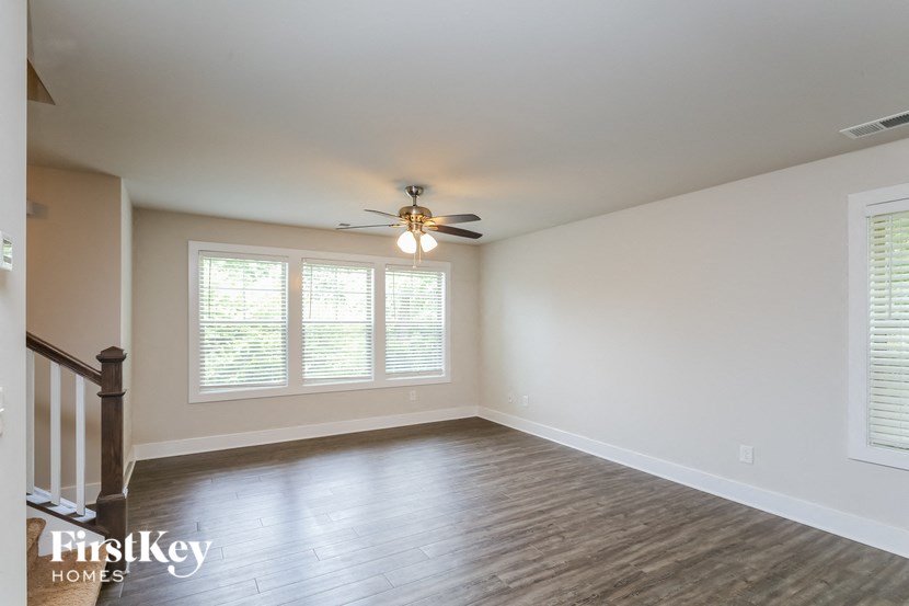 A room with a wooden floor and a ceiling fan.