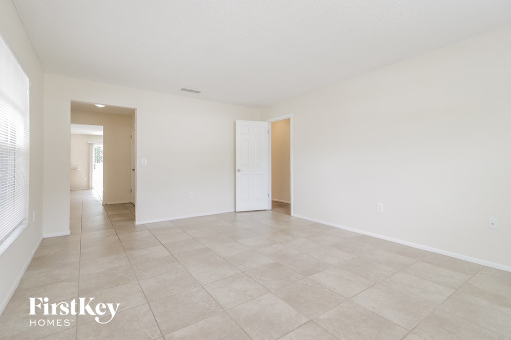 the living room and dining room are spacious and clean with tile flooring