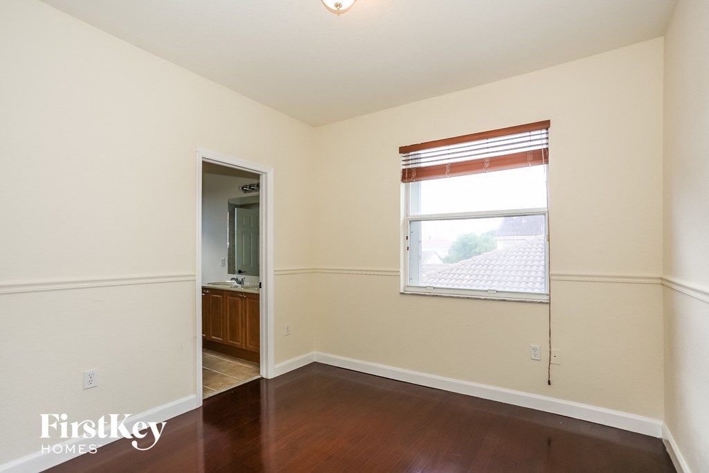 a living room with a window and a door to a bathroom