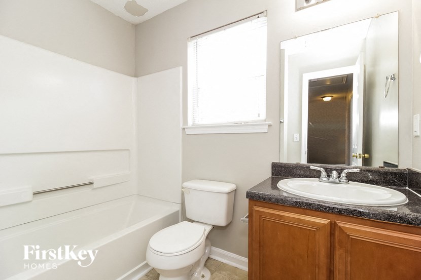 a small bathroom with a sink toilet and bath tub
