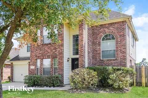 A brick house with a black door and a window.
