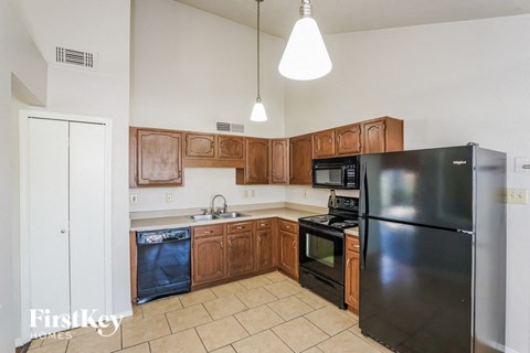 a kitchen with black appliances and wooden cabinets